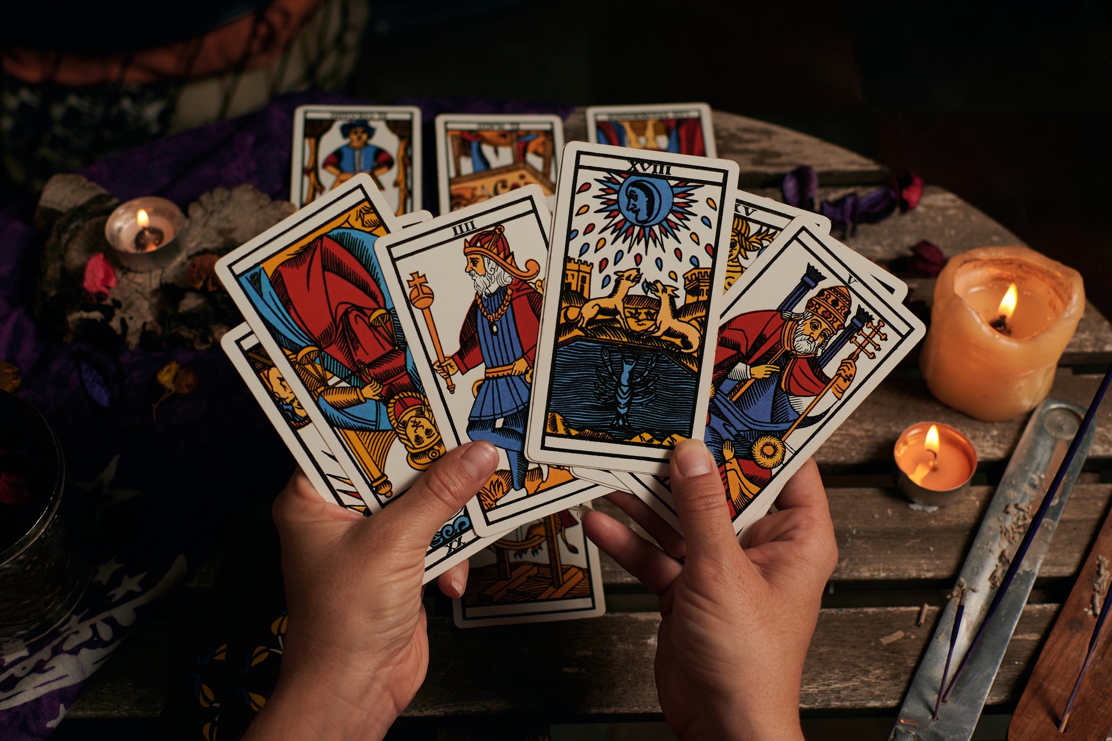 Colorful Tarot Cards on Hands